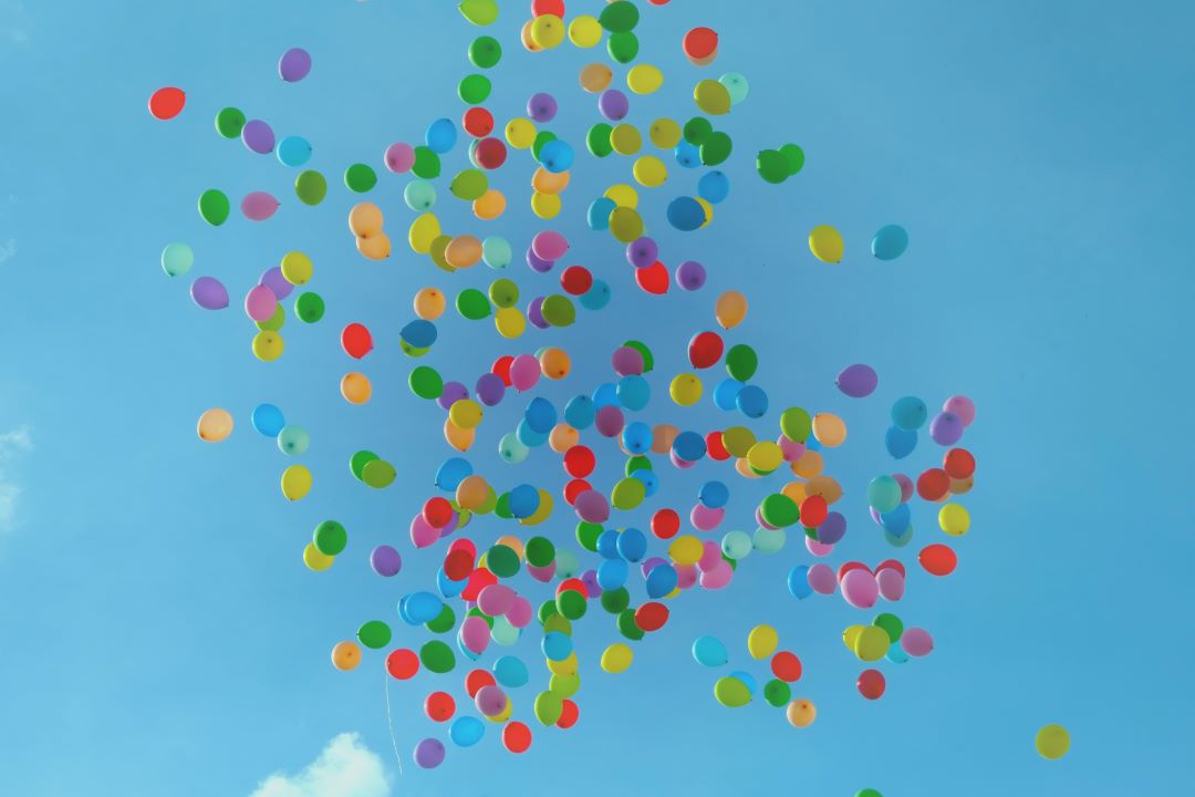 Balloons flying through the sky to signify an awards celebration